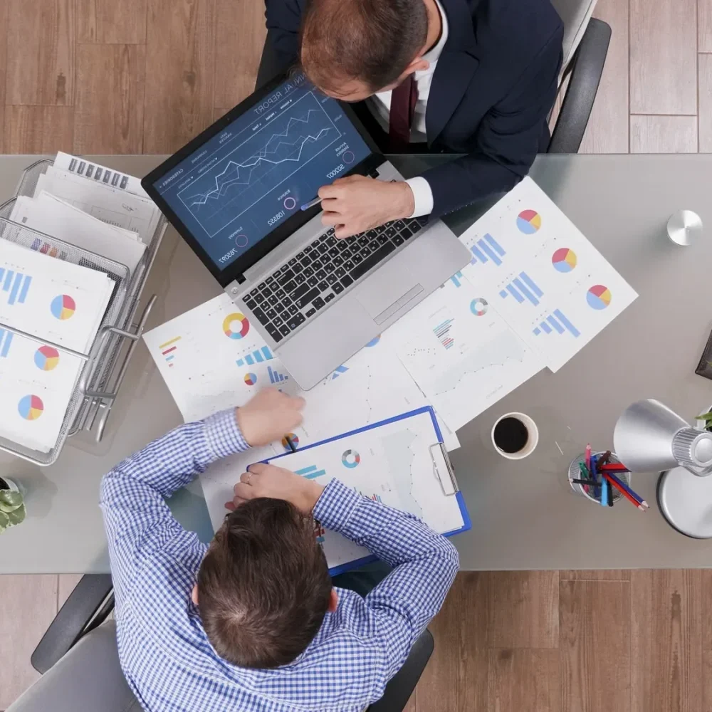 top-view-of-businessmen-analyzing-management-statistics-while-working-at-company-investments